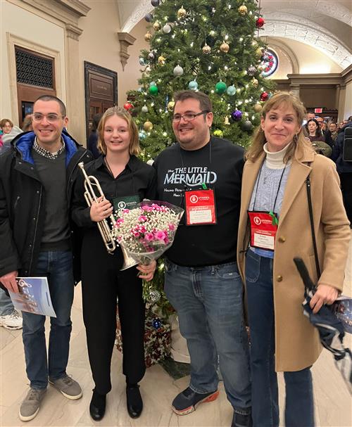 four people pose for photo